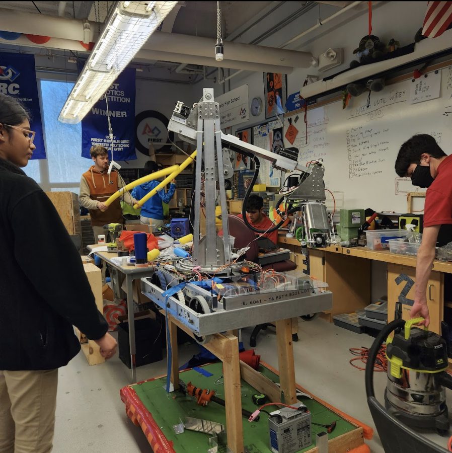 (L-R) Pacey Mahar ‘23, Eric Coppinger ‘24, Maanit Malhan ‘23, working on the robot.