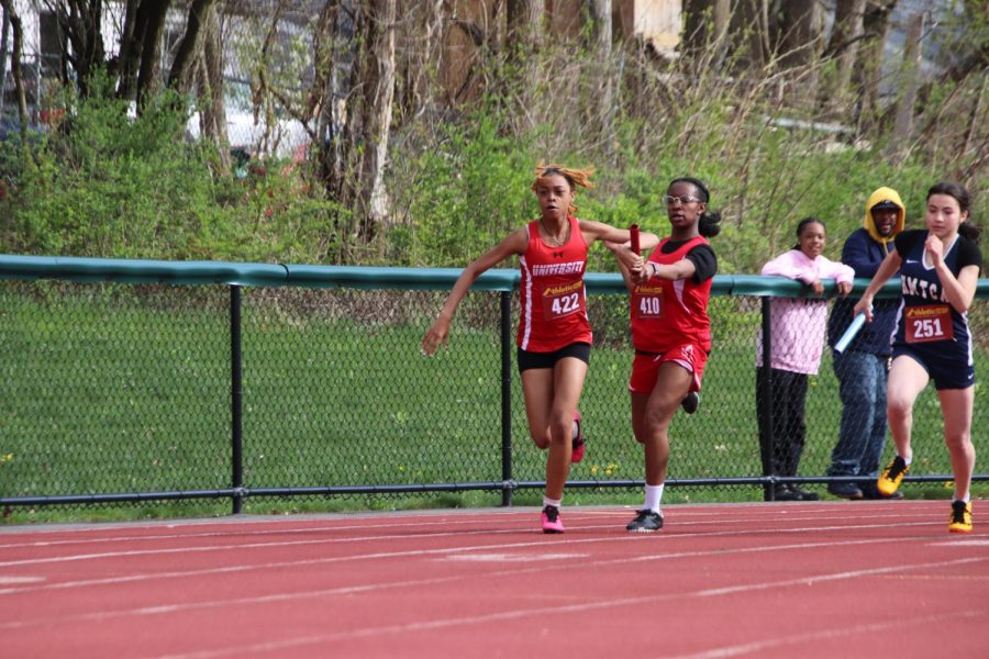 Amaris DeRosia-Estwick 26 passes Elysa Richards 25 the baton.