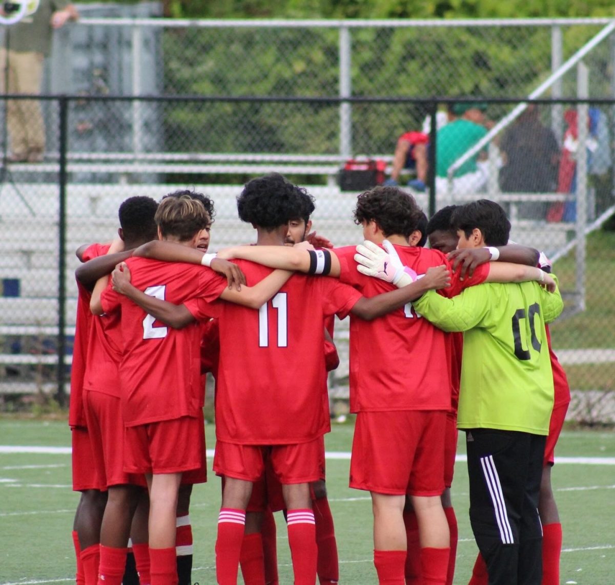 The Soccer team discussing strategy before a game. 