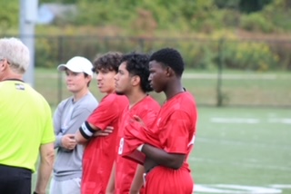 Team Captains pictured next to Coach Silenok  at a game.